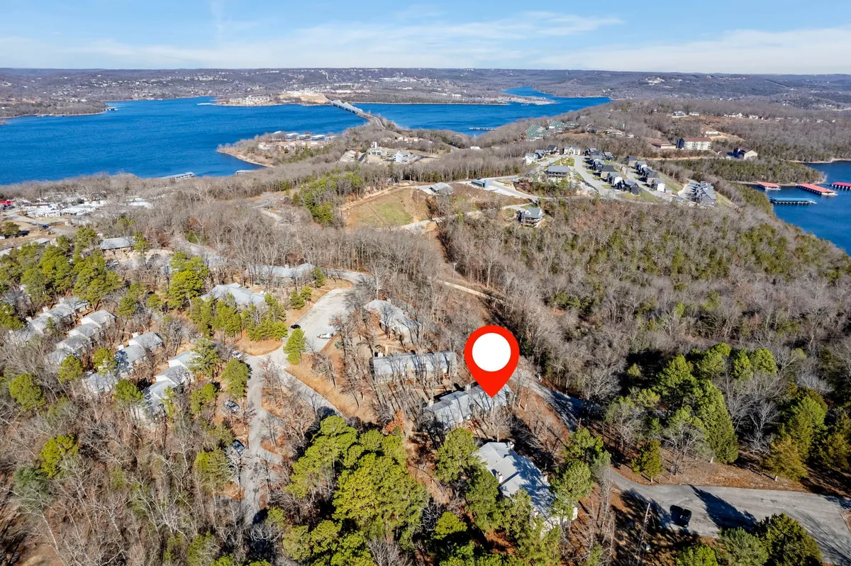 A sweeping view of the lake bordered by forest and dotted with roadways and buildings, this image evokes the sense of adventure and exploration that comes with being close to nature and the local community.
